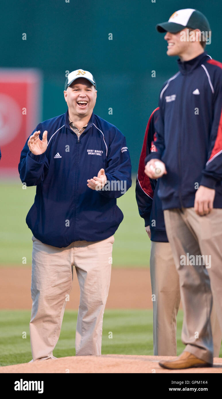 April 5, 2010; Oakland, CA, USA;  Saint Marys Gaels mens basketball head coach Randy Bennett (left) applauds guard Mickey McConnell (right) as he throws out the opening pitch before the game between the Oakland Athletics and the Seattle Mariners at Oaklan Stock Photo