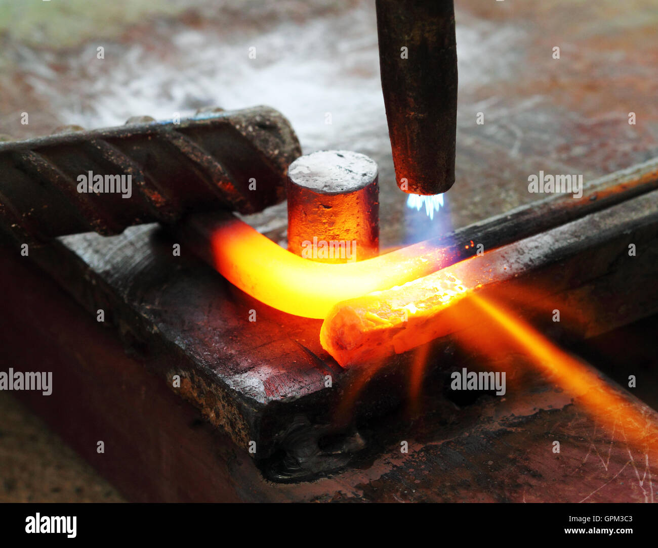 Gas heating cutting metal bending square bar Stock Photo Alamy