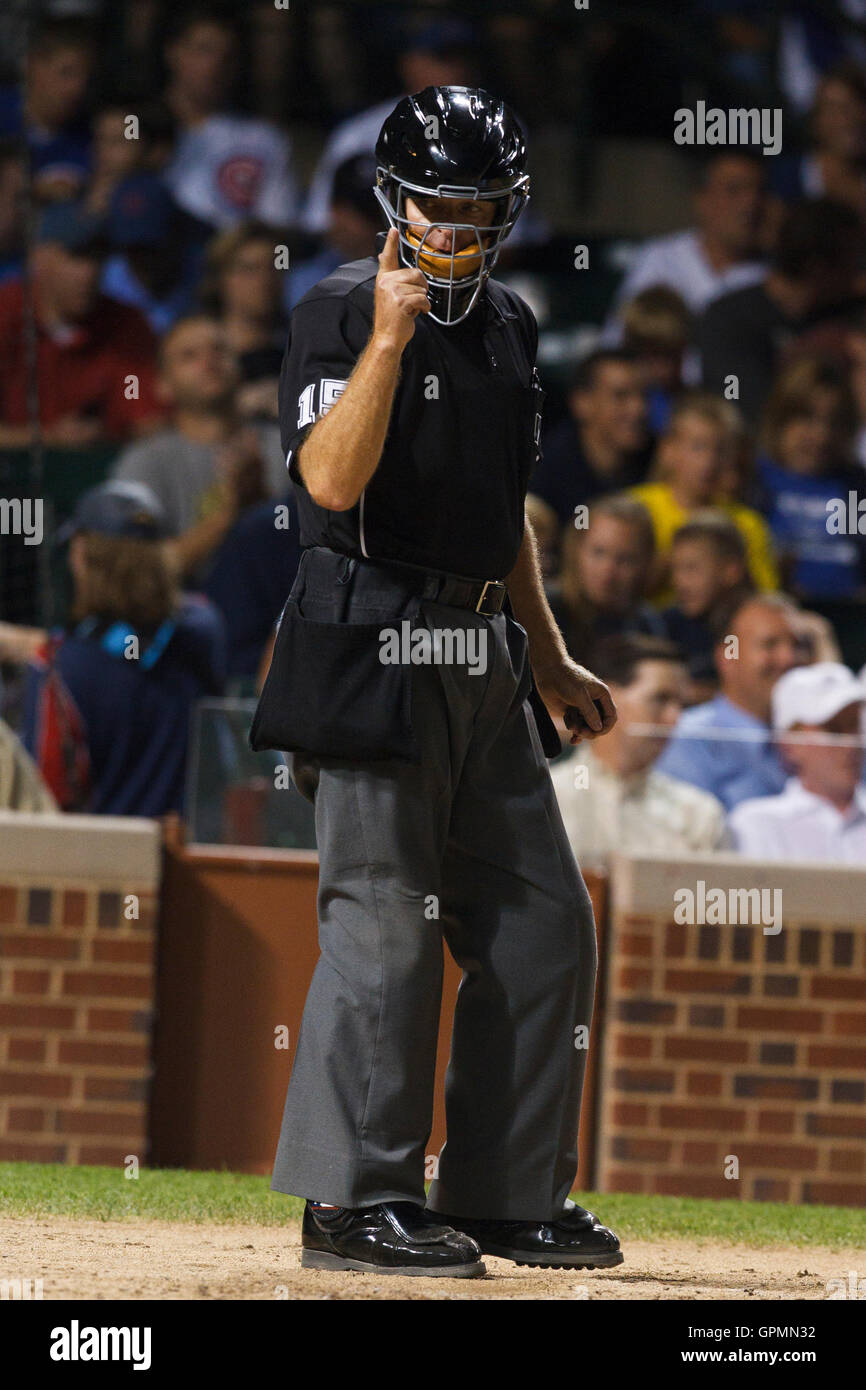 August 17, 2010; Chicago, IL, USA; Home plate umpire Ed Hickox (15) calls strike three on San Diego Padres starting pitcher Jon Garland (not pictured) during the fifth inning of the game against the Chicago Cubs at Wrigley Field. Stock Photo