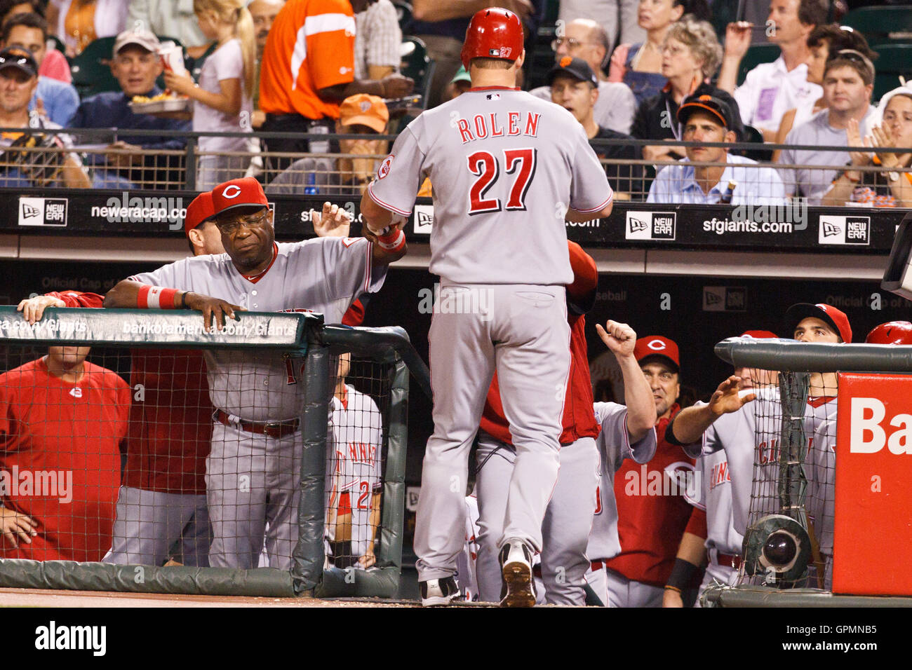 August 24, 2010; San Francisco, CA, USA;  Cincinnati Reds third baseman Scott Rolen (27) is congratulated by manager Dusty Baker (left) and teammates after hitting a two run home run against the San Francisco Giants during the fifth inning at AT&T Park. Stock Photo
