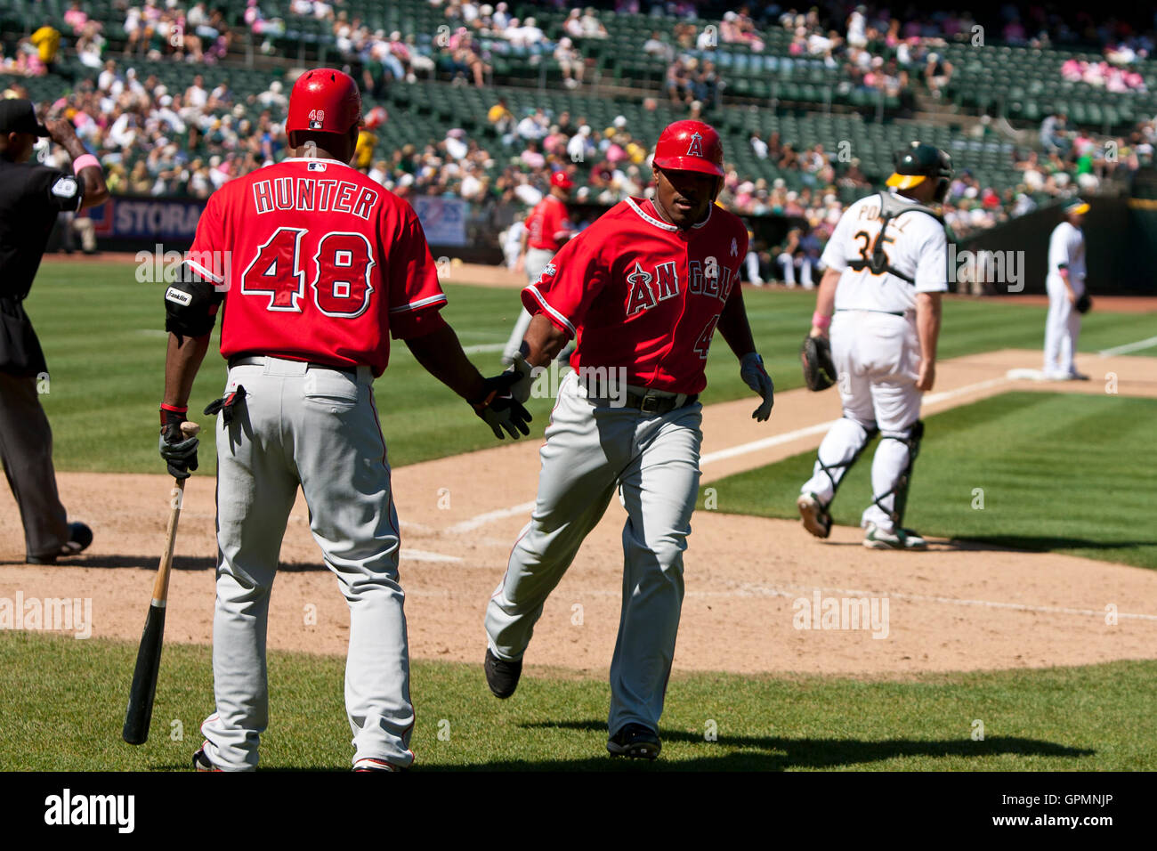 September 5, 2010; Oakland, CA, USA;  Los Angeles Angels second baseman Howard Kendrick (47) is congratulated by center fielder Torii Hunter (48) after scoring a run against the Oakland Athletics during the seventh inning at Oakland-Alameda County Coliseu Stock Photo