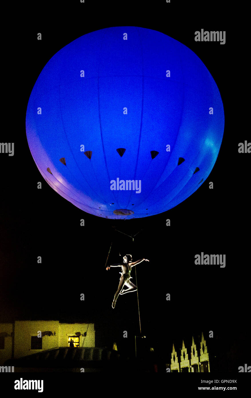 An acrobat is suspended below the Heliosphere, a giant helium balloon, as she performs during the Freedom Festival in Hull. Stock Photo