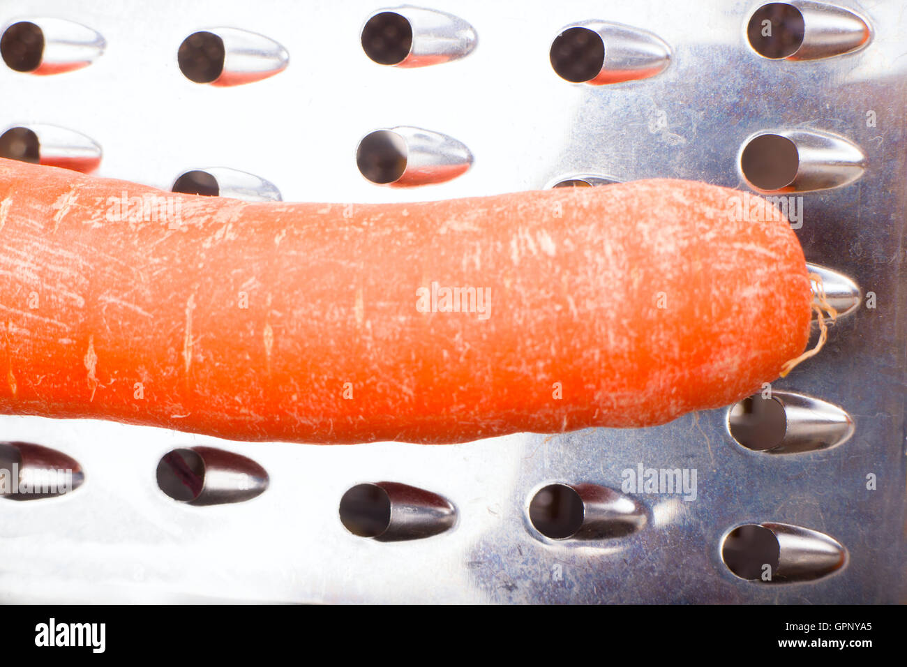 Metal grater and carrot on white background Stock Photo - Alamy