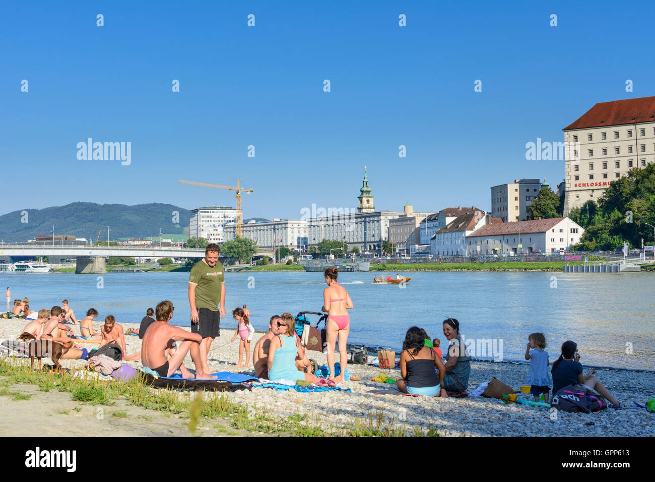 people at beach sunbathing at Danube, Old Town, castle, motorboat in Linz, , Oberösterreich, Upper Austria, Austria Stock Photo