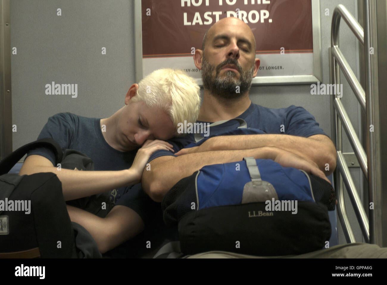 Tired couple take a cat nap on the F Train in Brooklyn, New York. Stock Photo