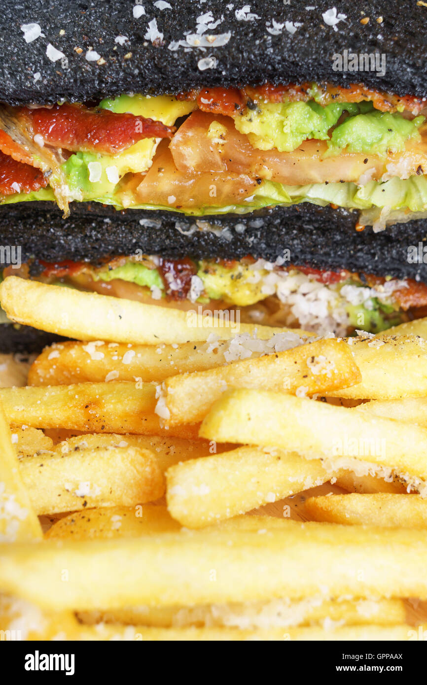 charcoal bread with guacamole bacon and tomato sanwich Stock Photo