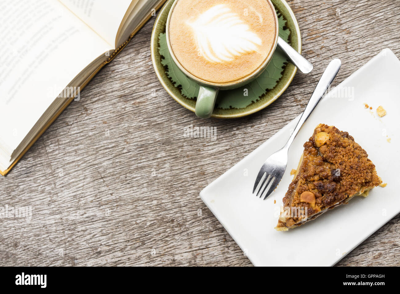 Leisure reading book with apple crumble pie and big coffee latte cup Stock Photo