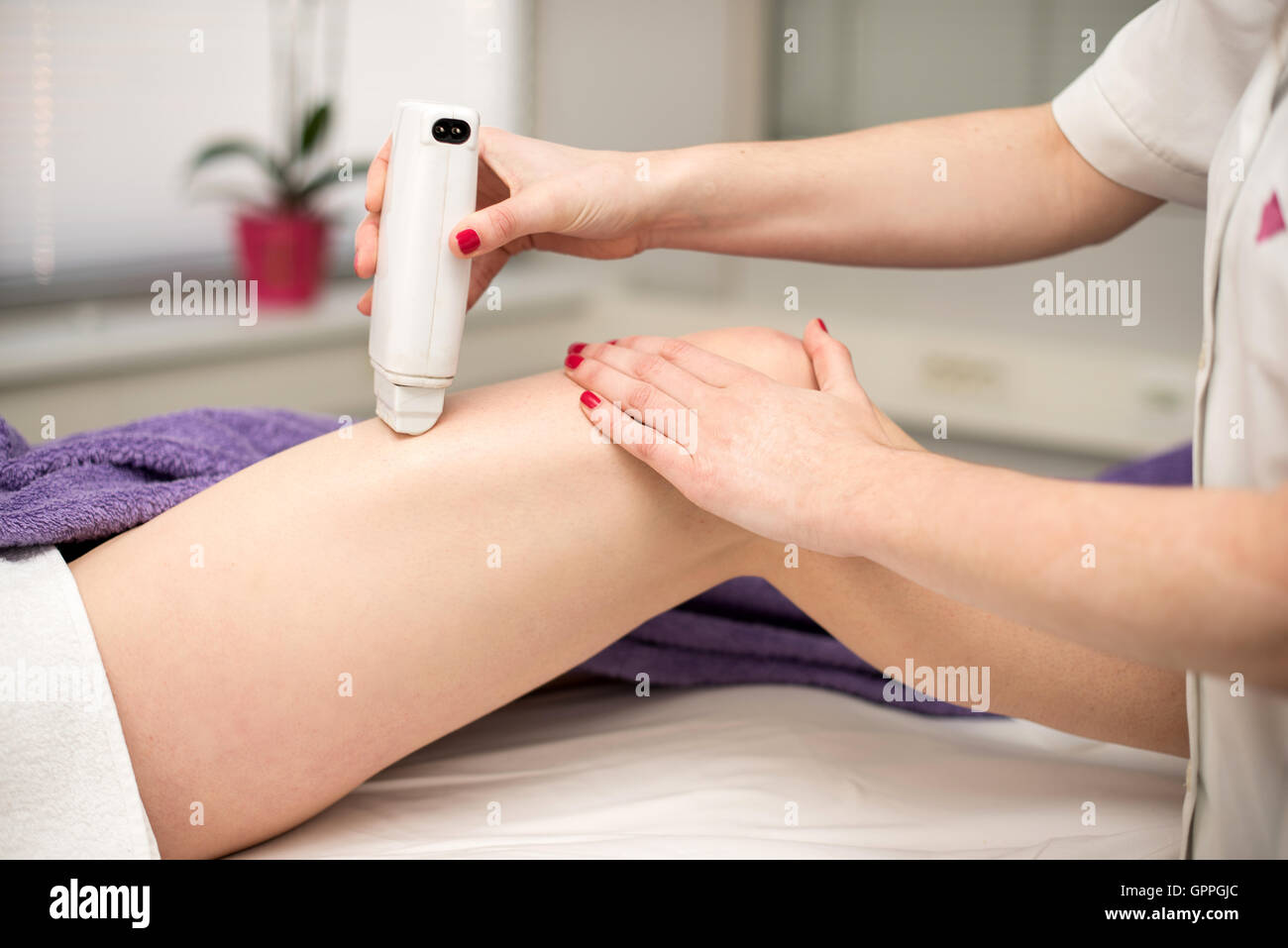 Hair removal cosmetology procedure from a therapist at cosmetic beauty spa clinic. Stock Photo