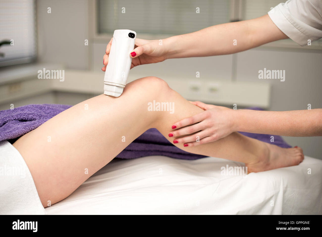 Hair removal cosmetology procedure from a therapist at cosmetic beauty spa clinic. Stock Photo