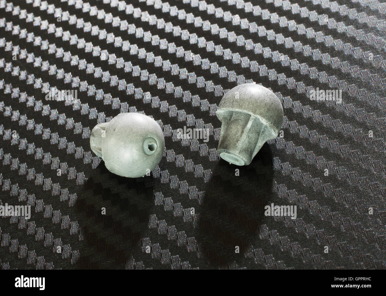 Pair of tiny foam ear plugs used with electronic hearing protection Stock Photo