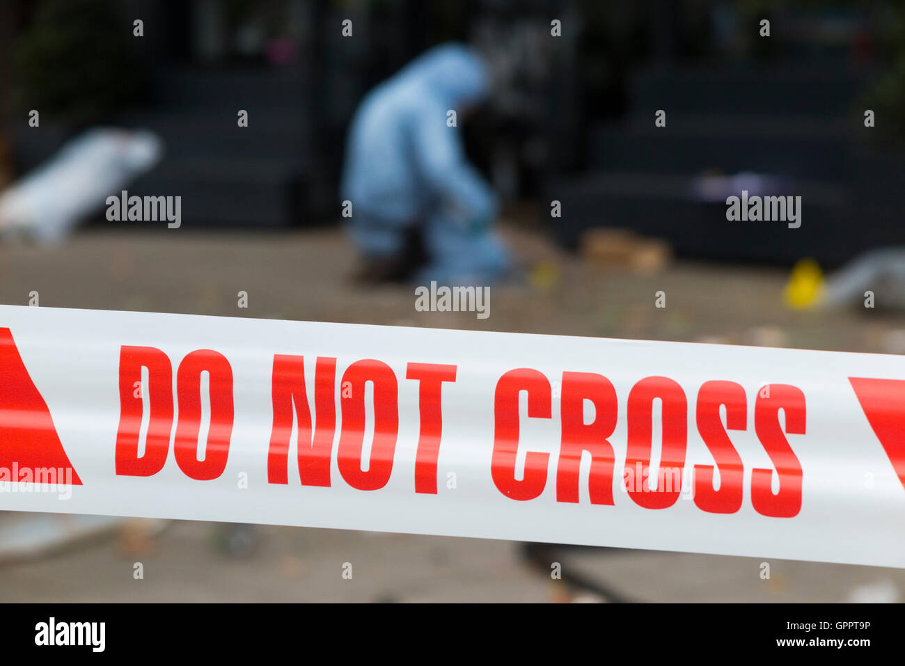 Police do not cross tape barrier & scene of crime officer / crimes