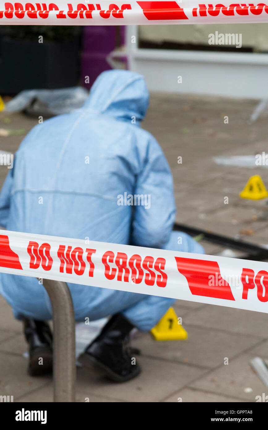 Police do not cross tape barrier & scene of crime officer / crimes