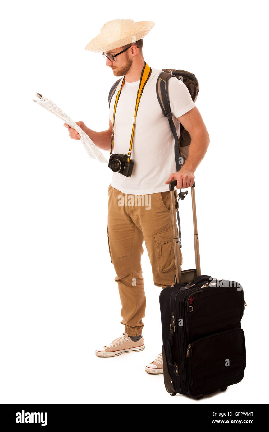 Traveler with straw hat, white shirt, backpack and suitcase waiting for transport isolated. Stock Photo