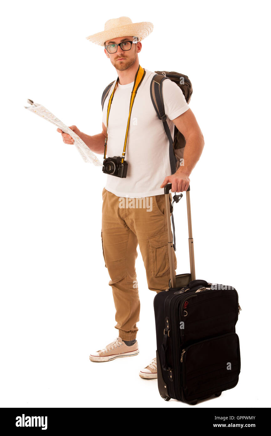 Traveler with straw hat, white shirt, backpack and suitcase waiting for transport isolated. Stock Photo