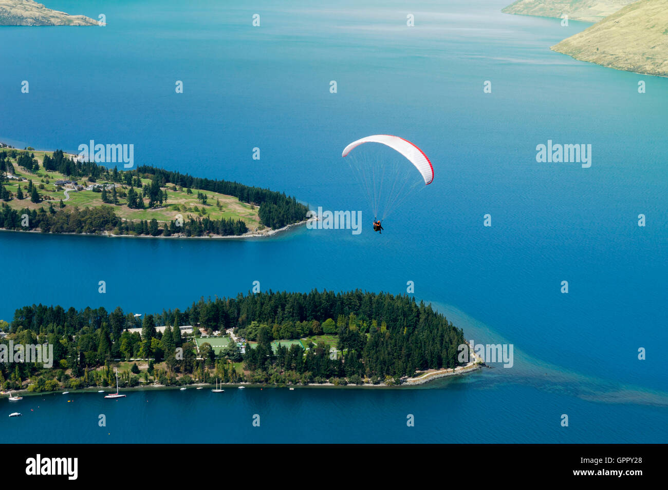 Tandem paragliding over Lake Wakatipu in Queenstown, New Zealand Stock Photo