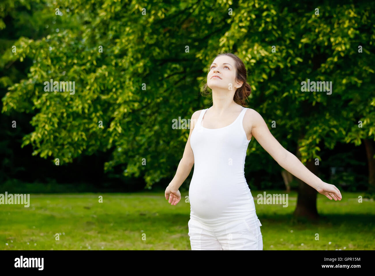 Beautiful pregnant woman in the park Stock Photo - Alamy