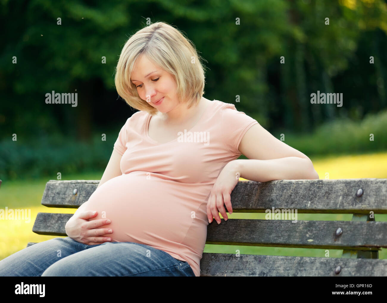Pregnant woman in the park Stock Photo - Alamy