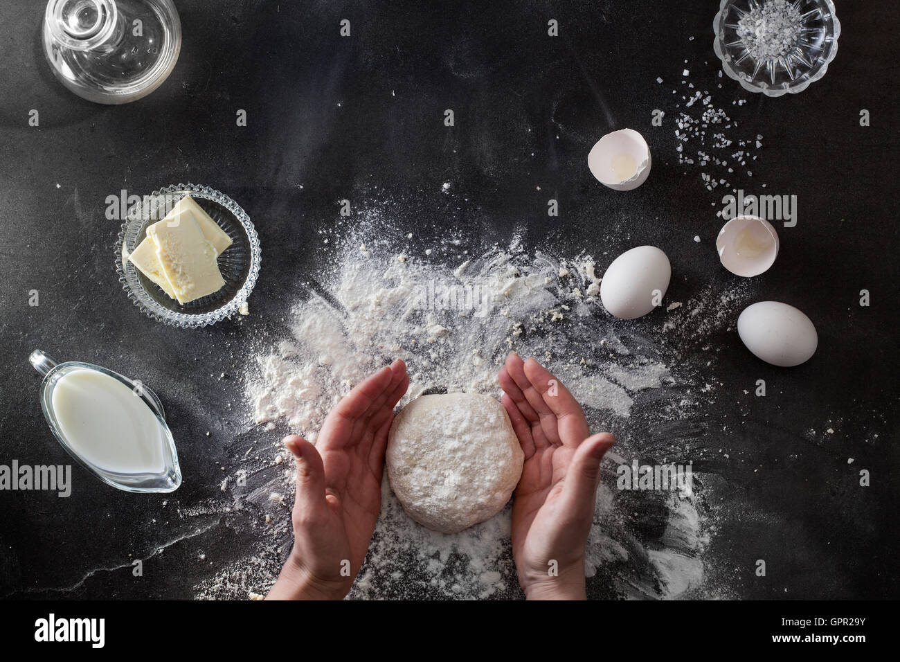Woman's hands knead dough on table with flour Stock Photo Alamy
