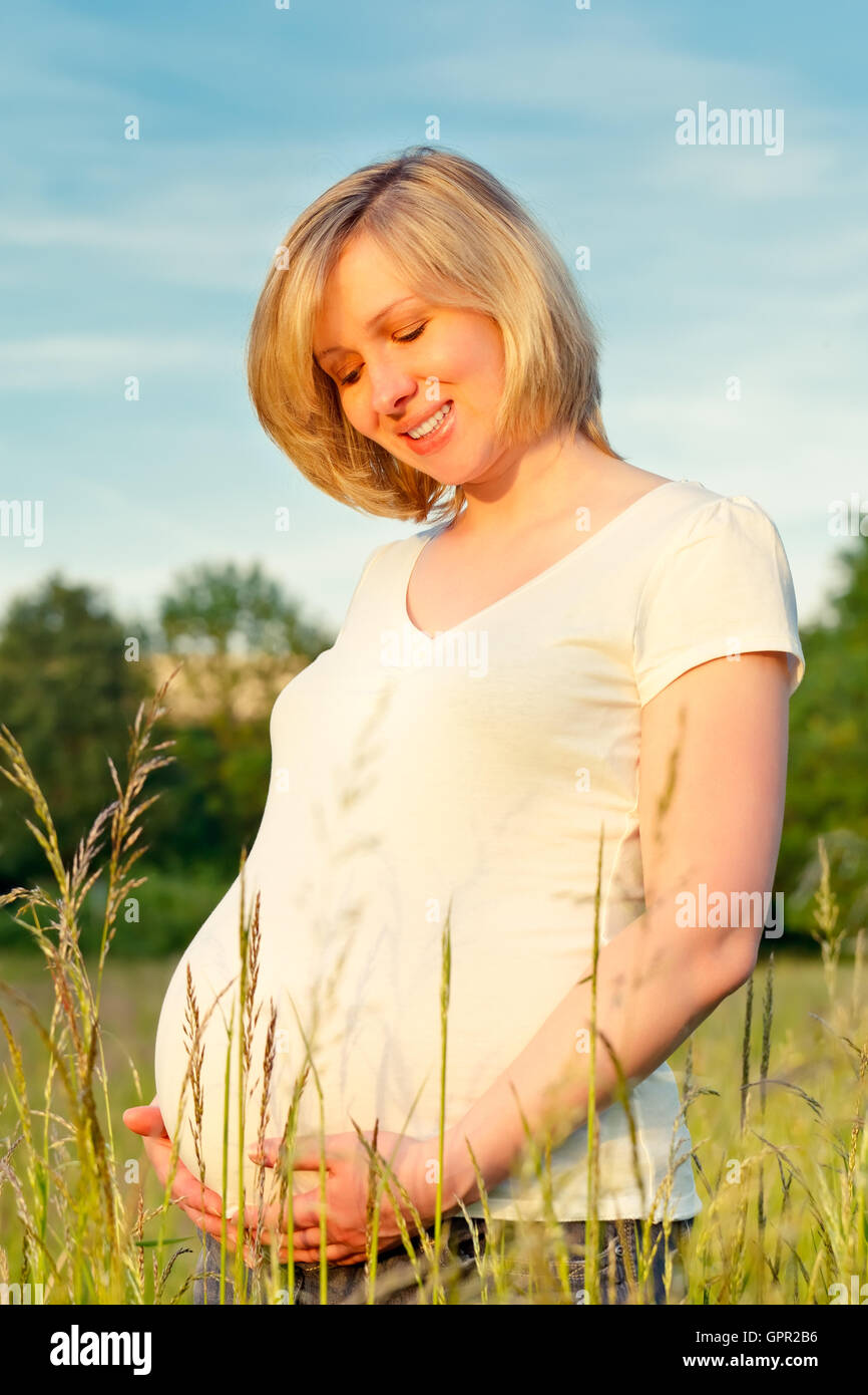 Pregnant woman in the park Stock Photo - Alamy