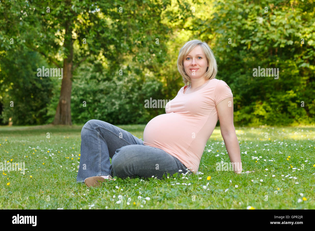 Pregnant woman in the park Stock Photo - Alamy