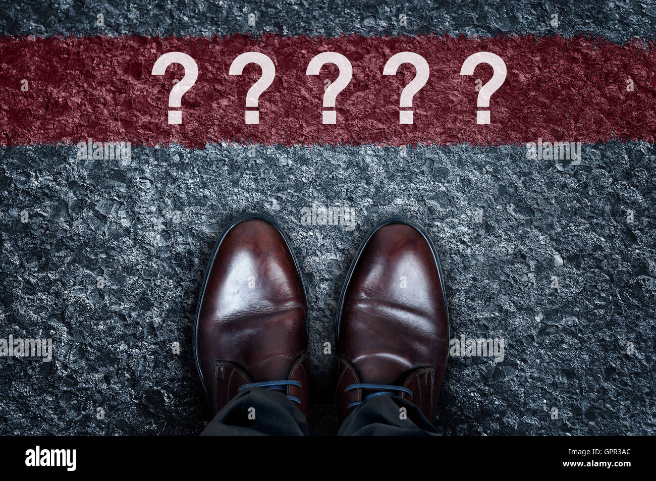 Question marks message on asphalt and business shoes Stock Photo