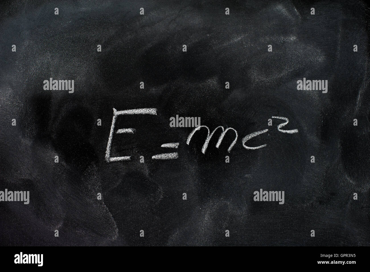 Einstein relativity formula e=mc2 white chalk drawing on dusty black school board Stock Photo
