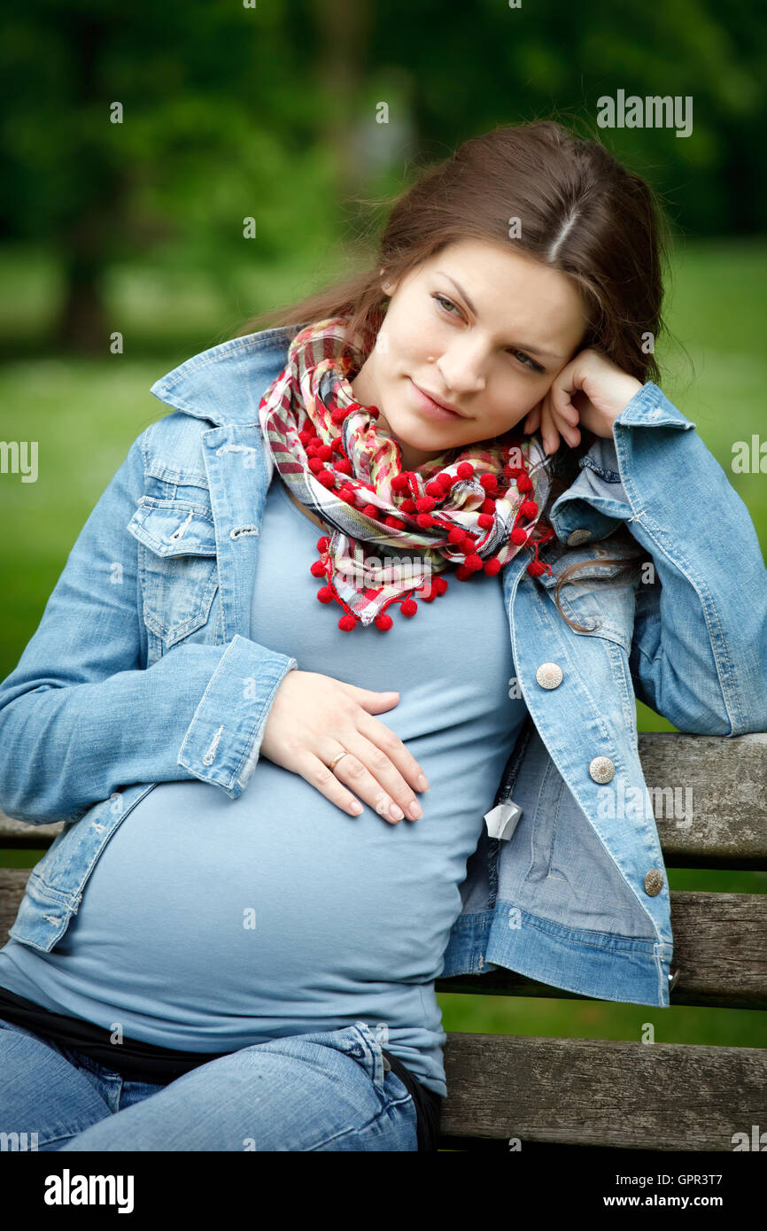 Pregnant woman relaxing in the park Stock Photo - Alamy