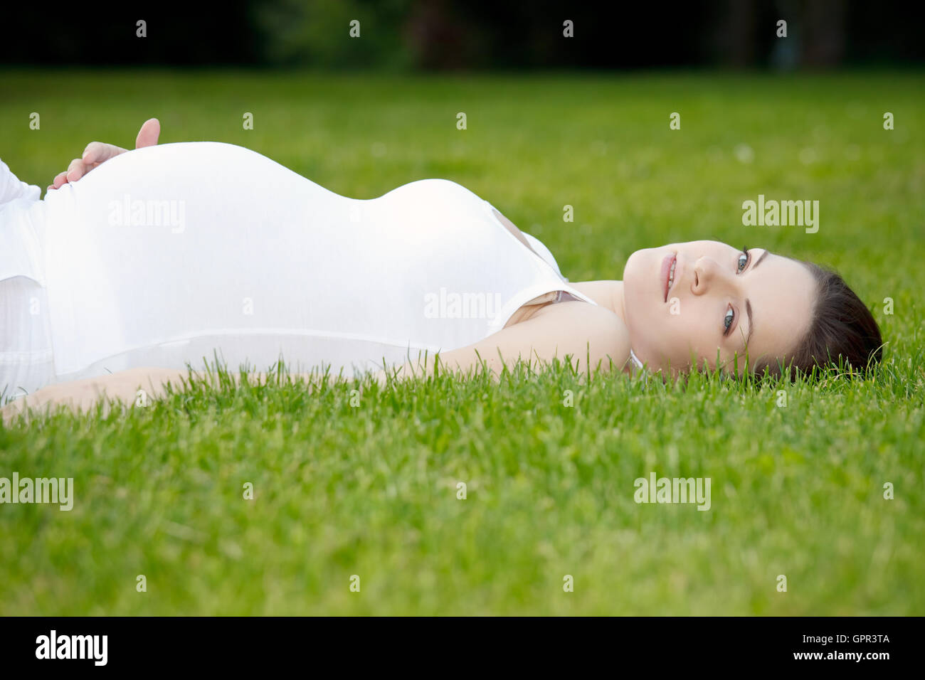 Beautiful pregnant woman in the park Stock Photo - Alamy