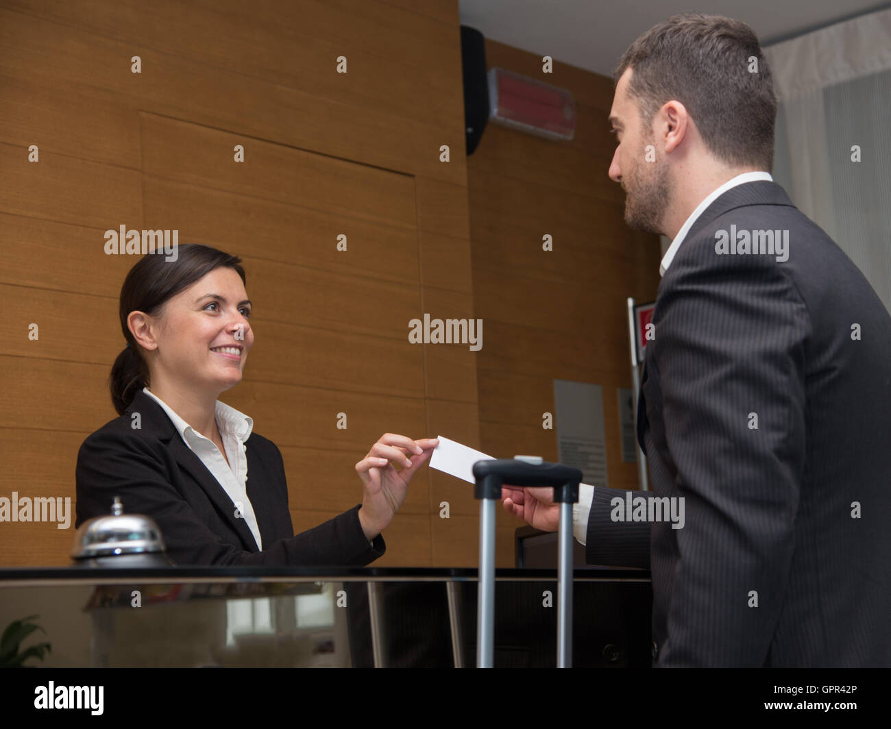 Businessman is arrived in hotel and is checkingin Stock Photo Alamy