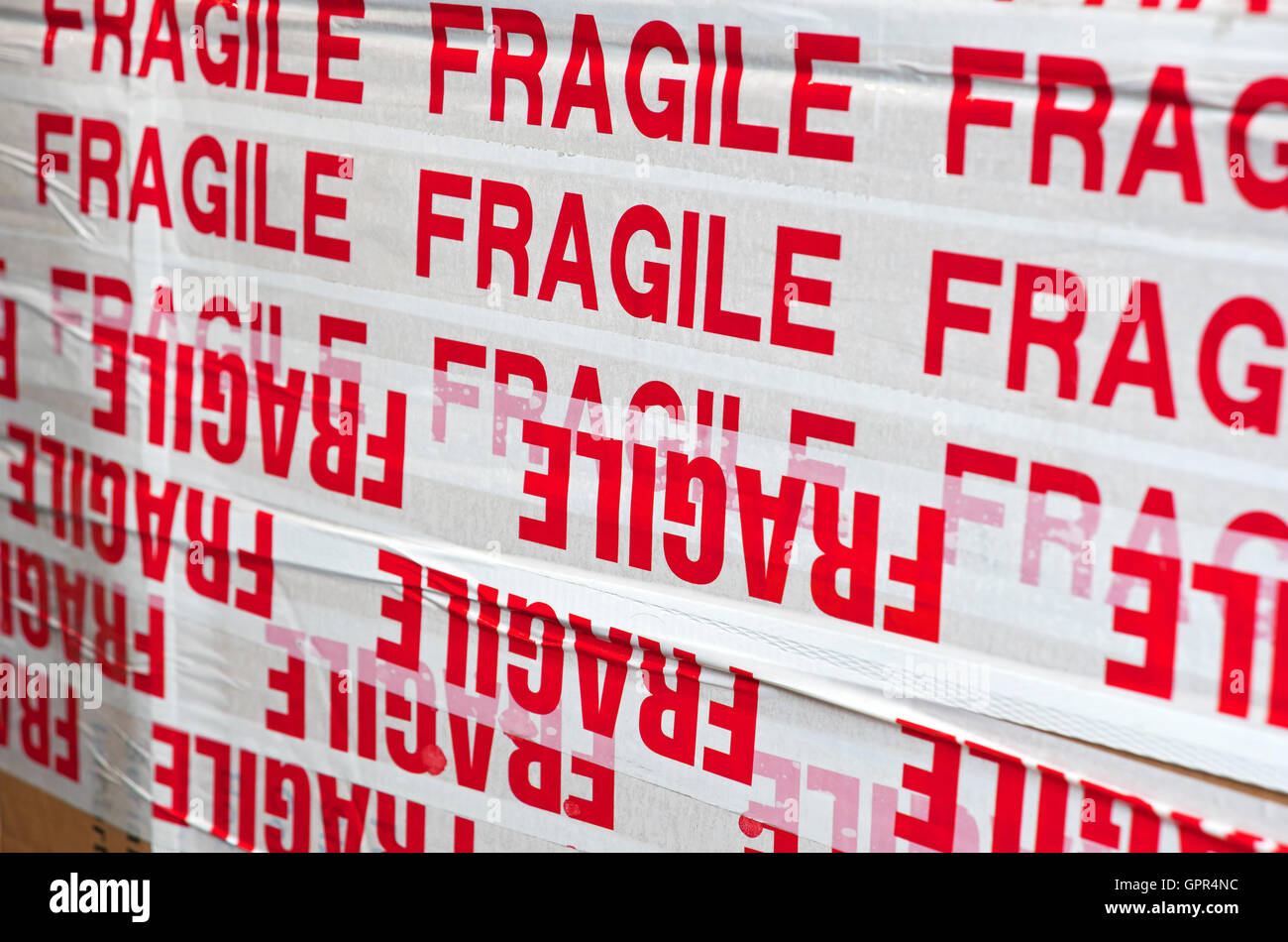 Close up of box package packaging parcel covered in tape marked fragile
