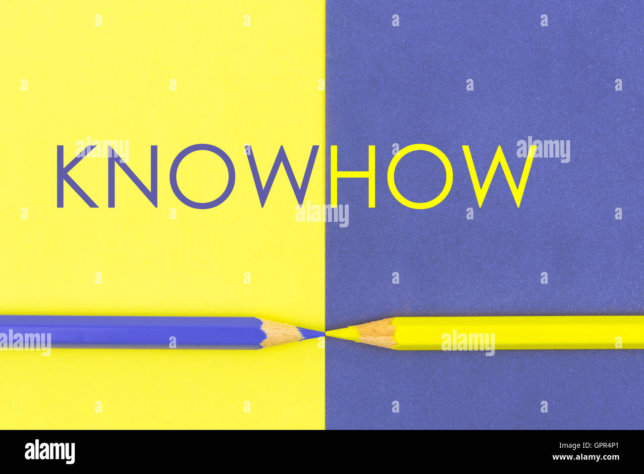 KnowHow concept with Yellow and Violet coloured pencils and paper. Stock Photo