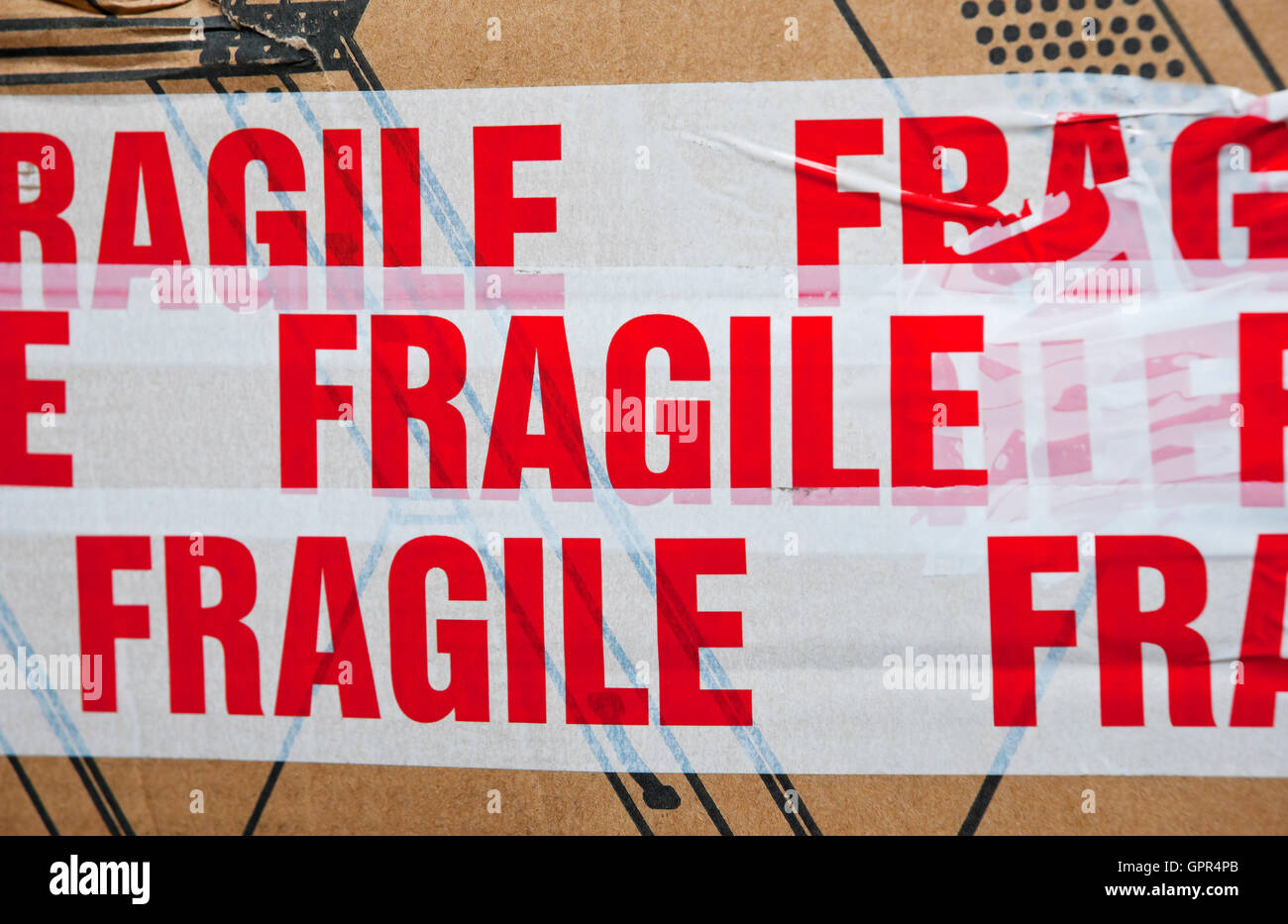 Close up of box package packaging parcel covered in tape marked fragile