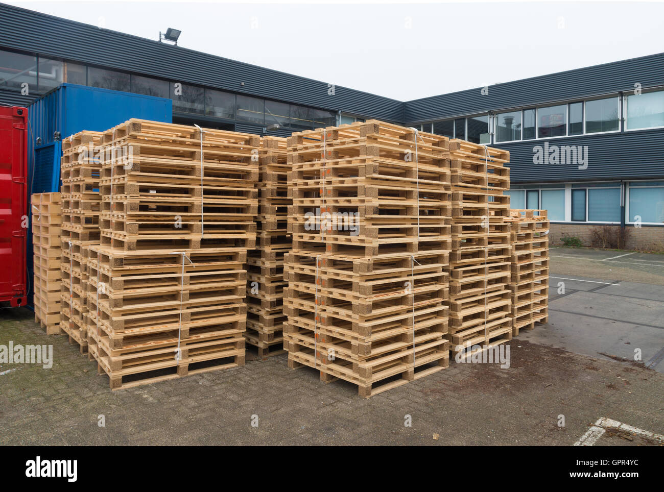 piles of wooden pallets on a factory backyard Stock Photo