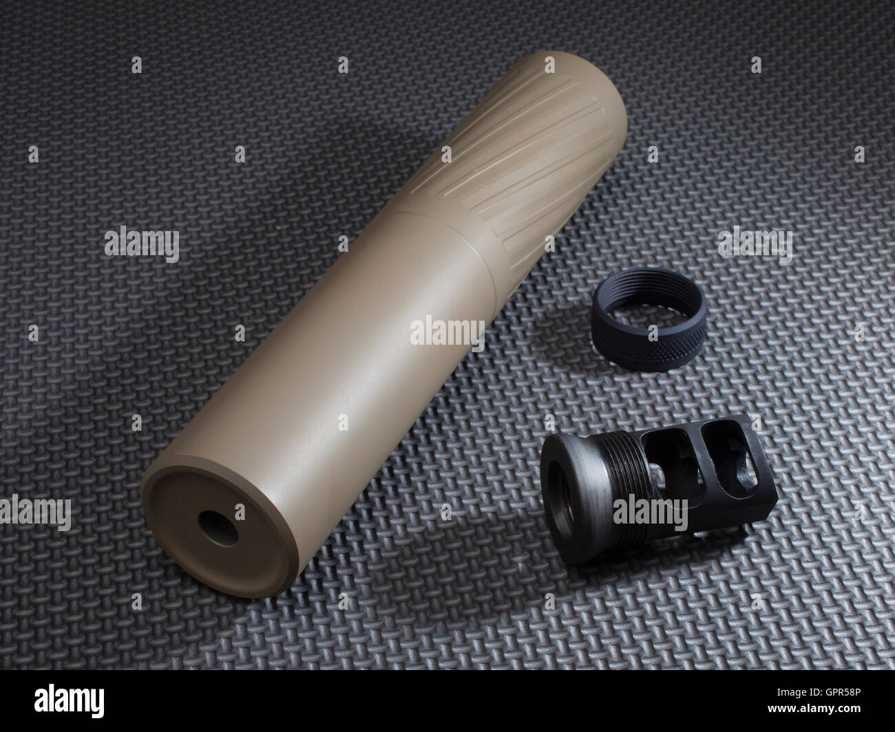 Suppressor and adapter that holds it on a rifle barrel Stock Photo - Alamy