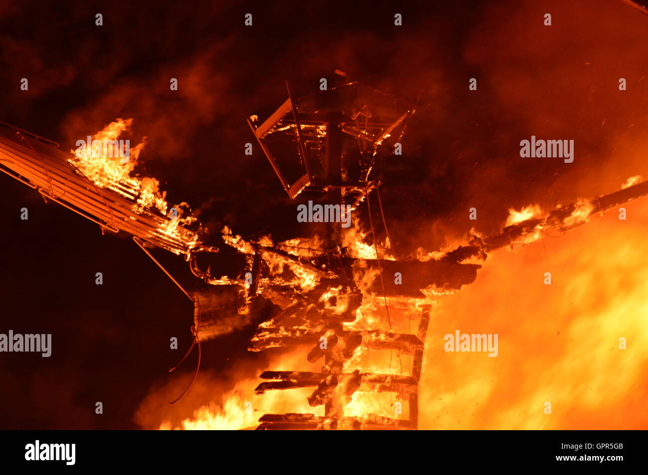 The Burning Man sculpture is set fire during the final celebration at the annual desert festival Burning Man September 3, 2016 in Black Rock City, Nevada. Stock Photo