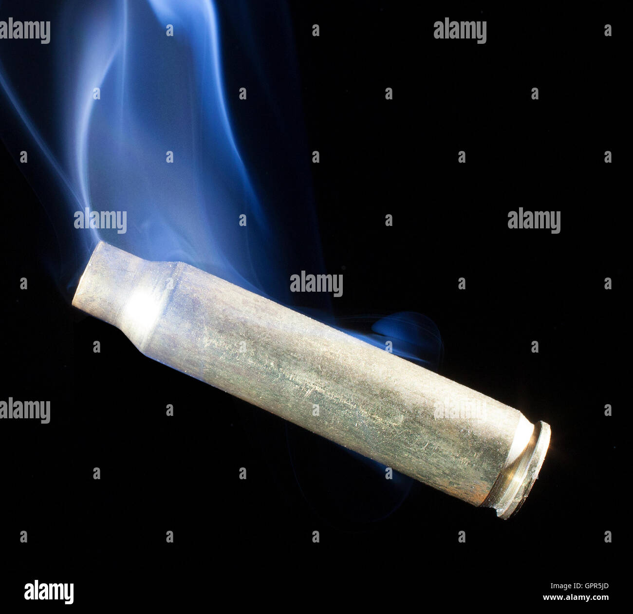 Brass from a cartridge that is smoking after a shot Stock Photo Alamy