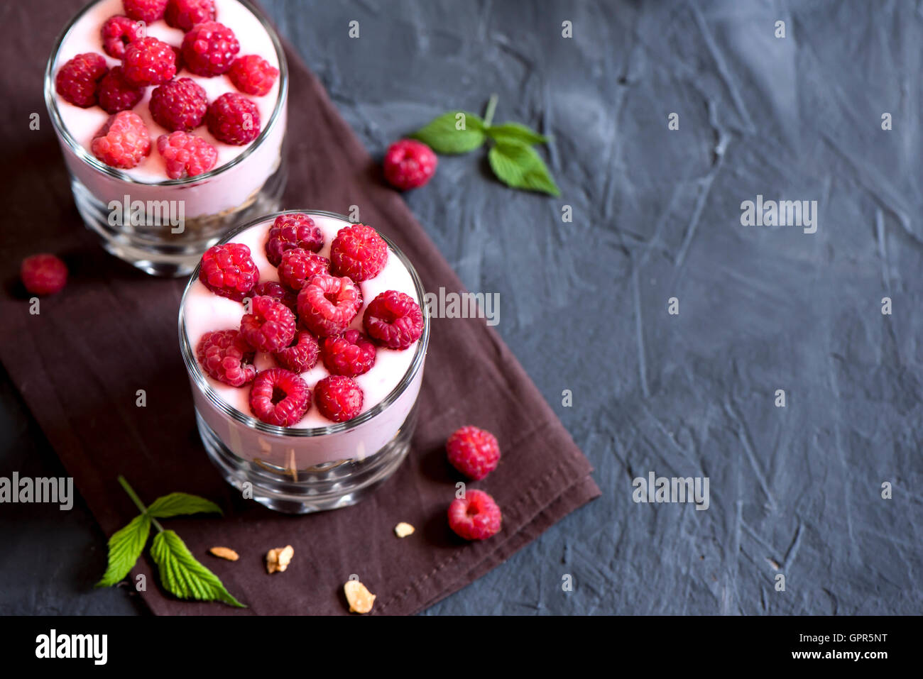 Homemade organic fresh parfait dessert with raspberries and granola, selective focus, copy space Stock Photo