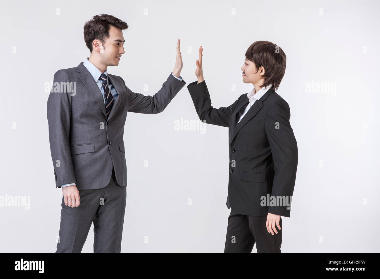 Businessmen slapping high fives Stock Photo