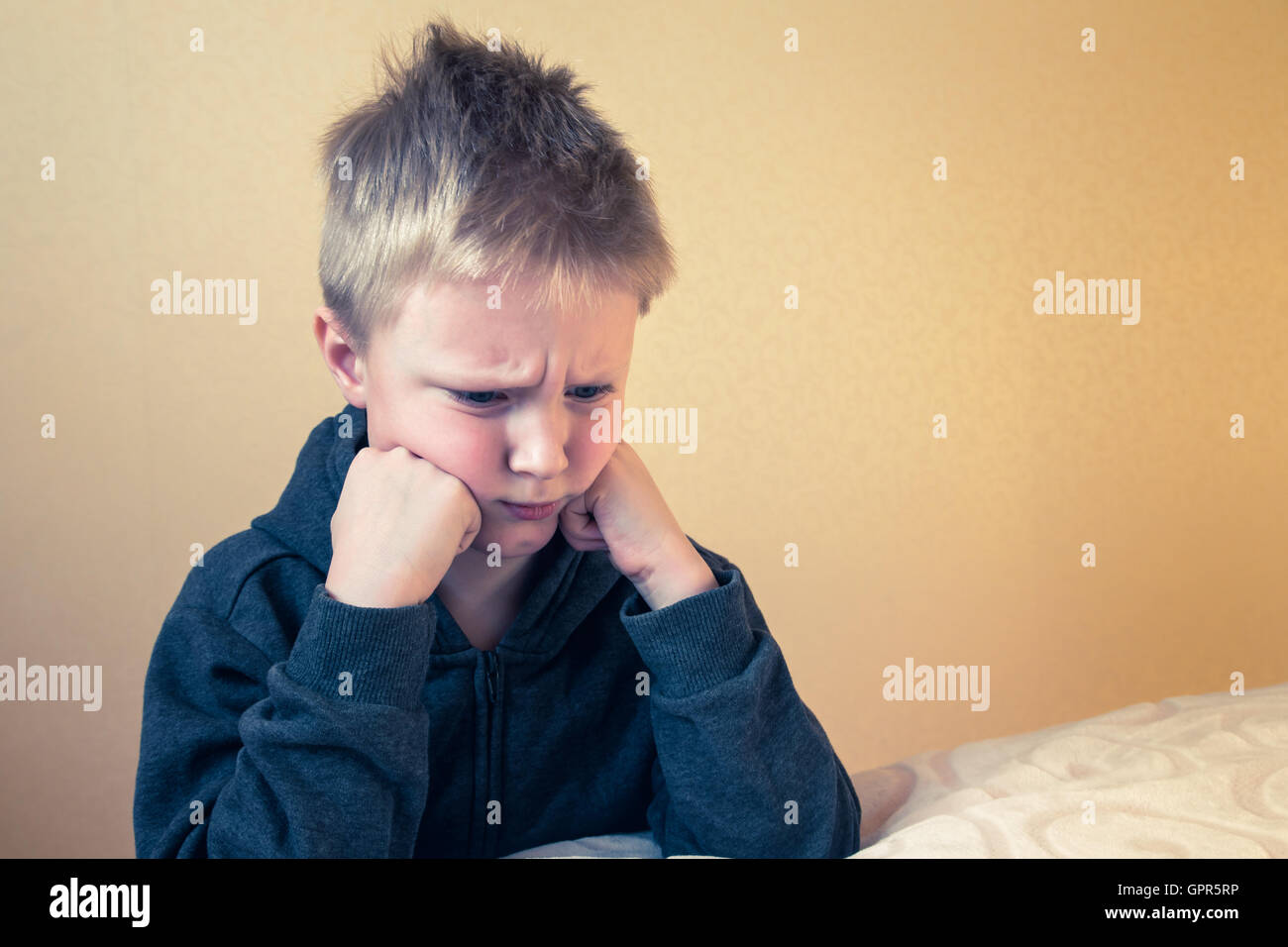 Sad upset tired worried unhappy kid (boy, teen) close up portrait with copy space Stock Photo