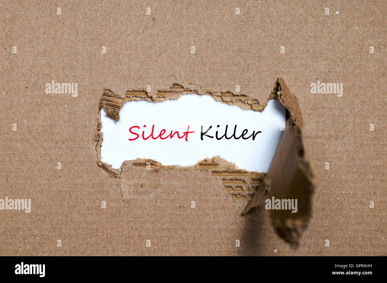 the-word-silent-killer-appearing-behind-torn-paper-stock-photo-alamy