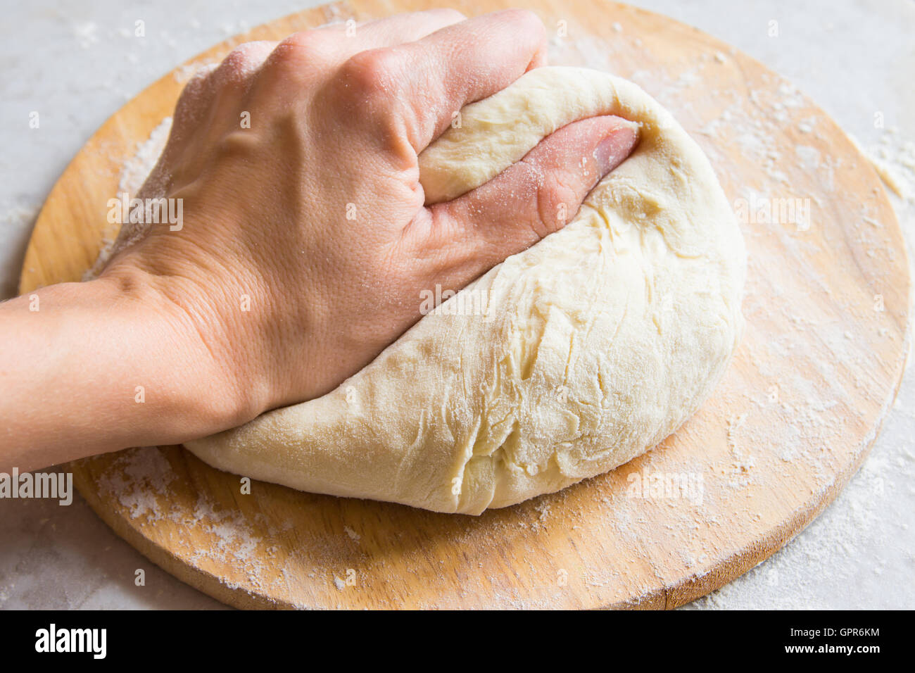 Hand knead dough on cutting board for homemade bakery Stock Photo Alamy