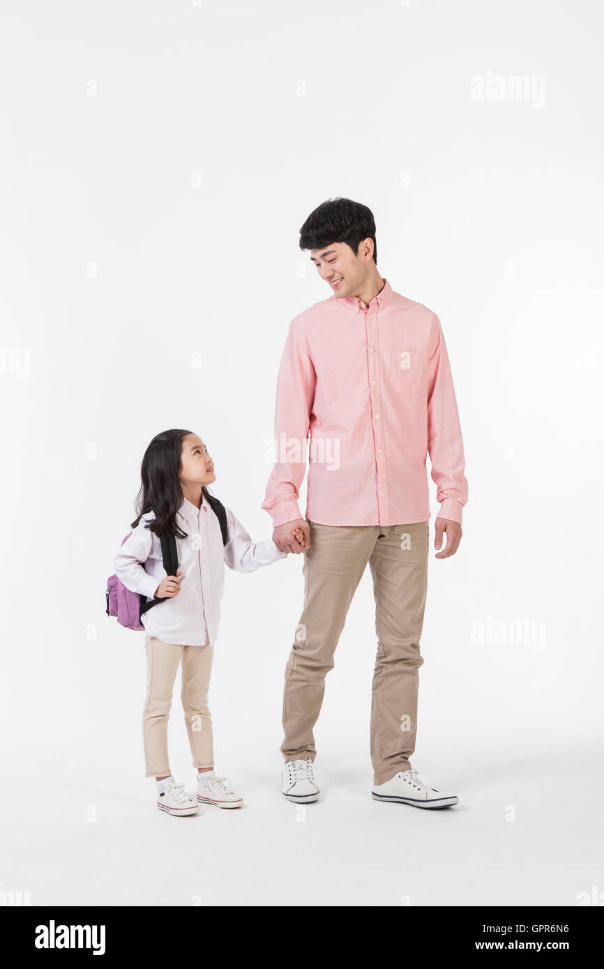 Loving father and daughter with school bag walking hand in hand Stock ...