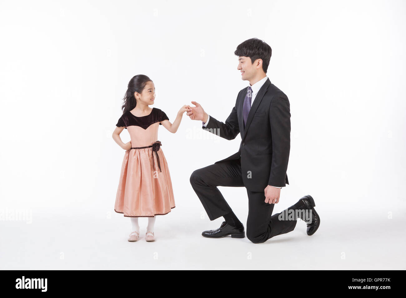 Smiling daughter and father holding hands Stock Photo - Alamy