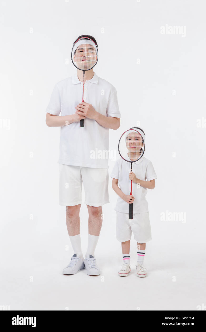 Father and daughter with badminton rackets Stock Photo
