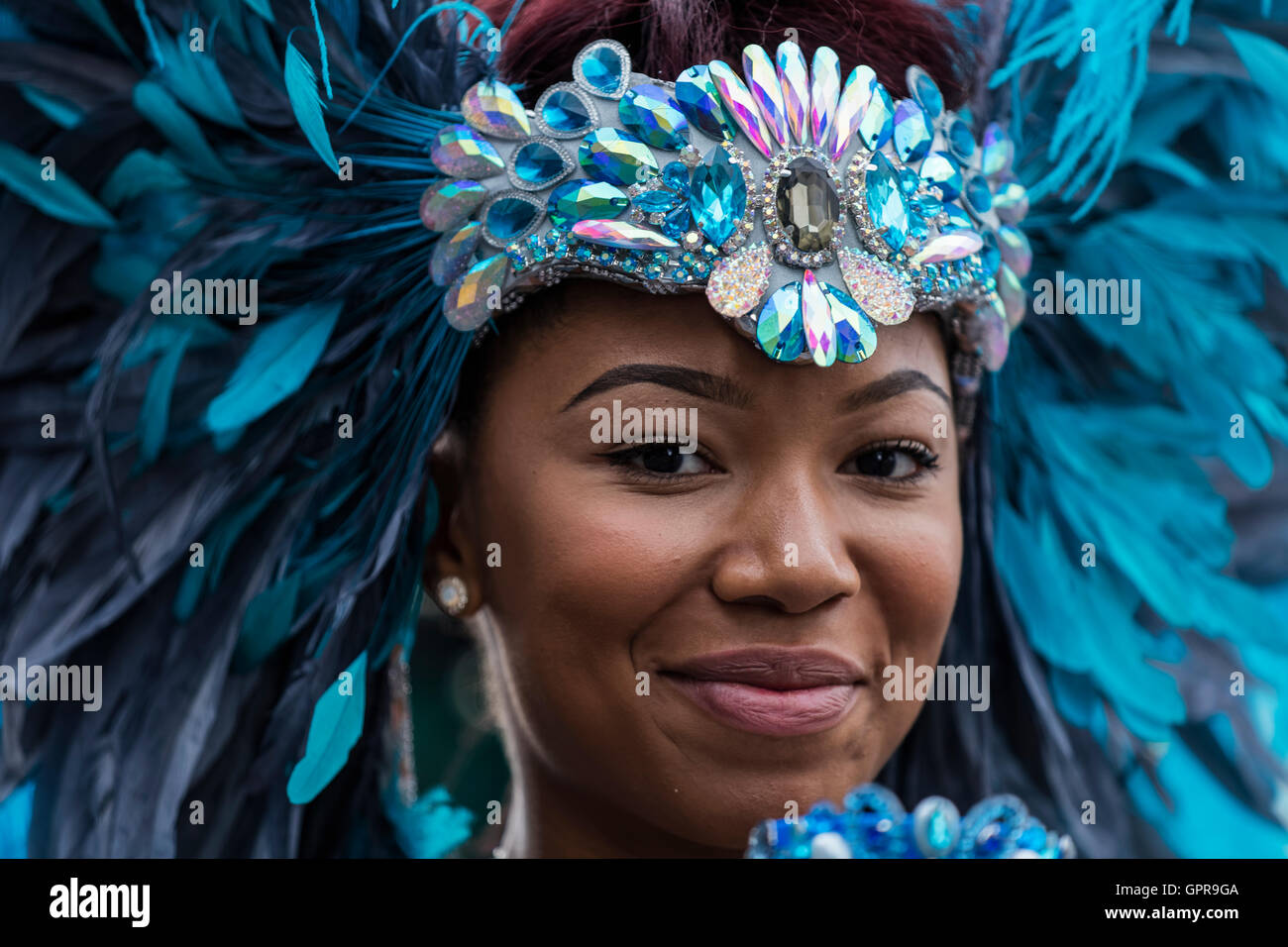 Black beautiful Afro Caribbean woman dressed in a blue feather