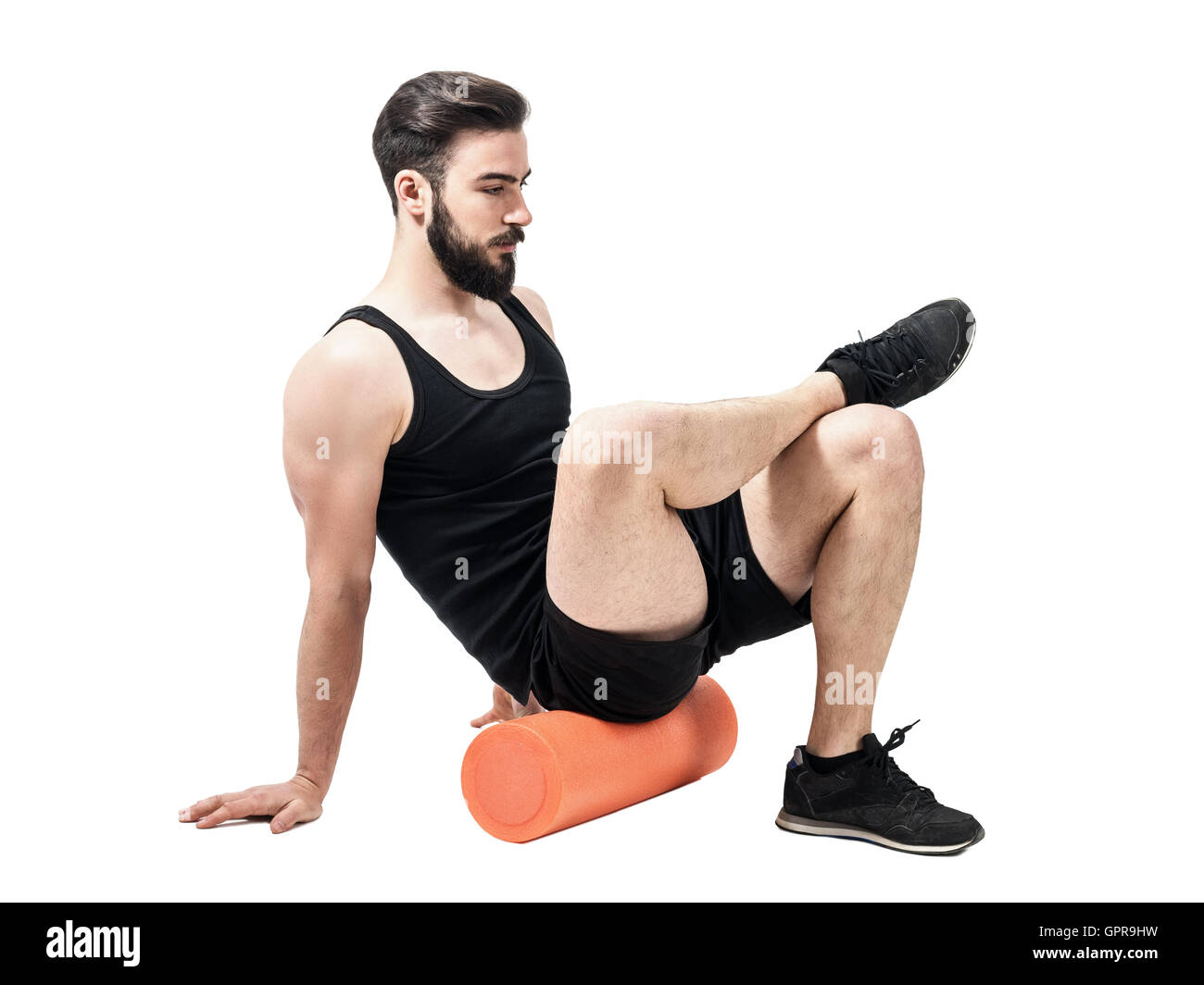 Athlete massaging glutes muscles with foam roller. Full body length  portrait isolated on white studio background Stock Photo - Alamy