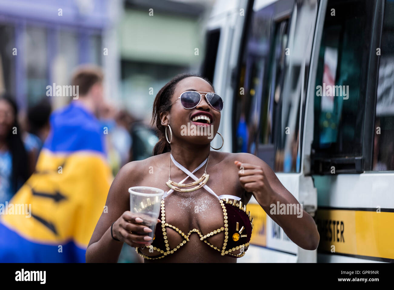 Black Afro Caribbean woman wearing sunglasses having fun at the Notting Hill carnival in West London Stock Photo