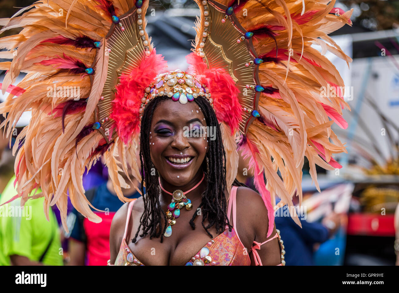 Beautiful black Afro Caribbean woman wearing feather costume at the Notting Hill Carnival in West London Stock Photo