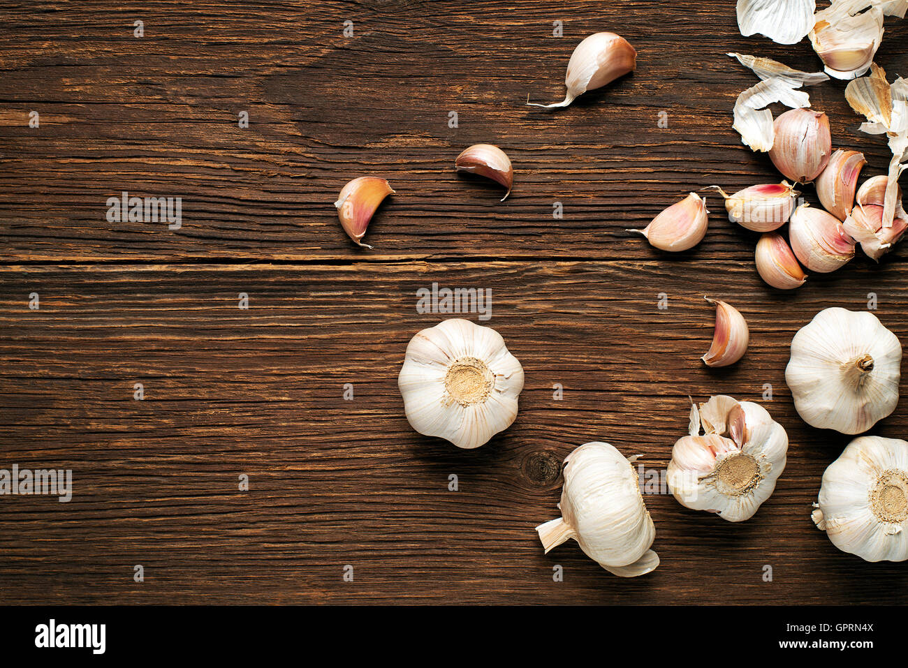 Garlic cloves on wooden vintage background Stock Photo - Alamy