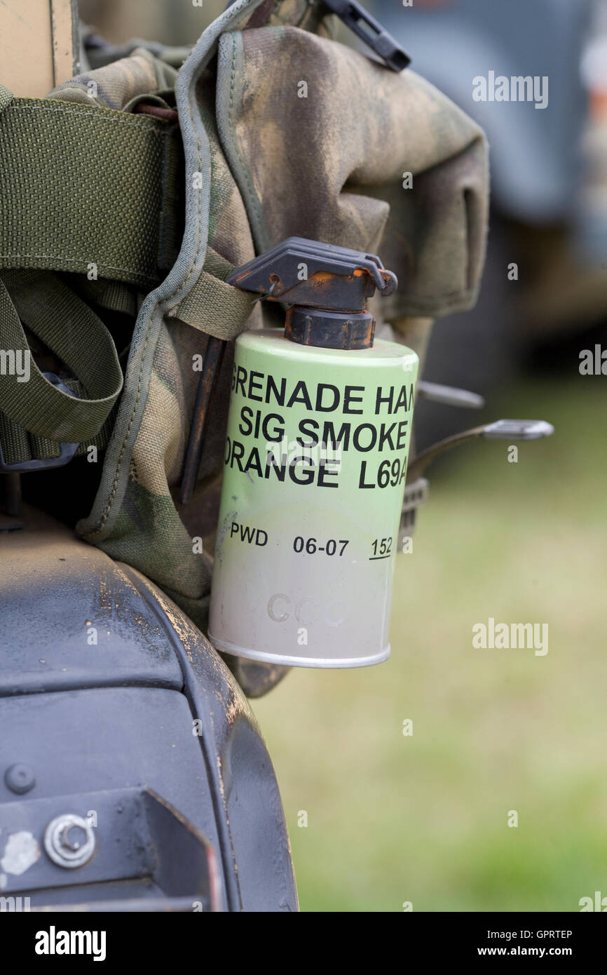 Smoke grenade attached to an armed services rucksack Stock Photo